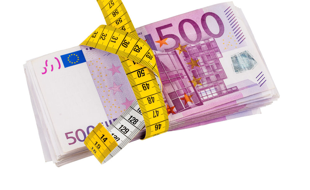 notes and tape measure, symbolic photo for austerity measures, fiscal consolidation and controlling