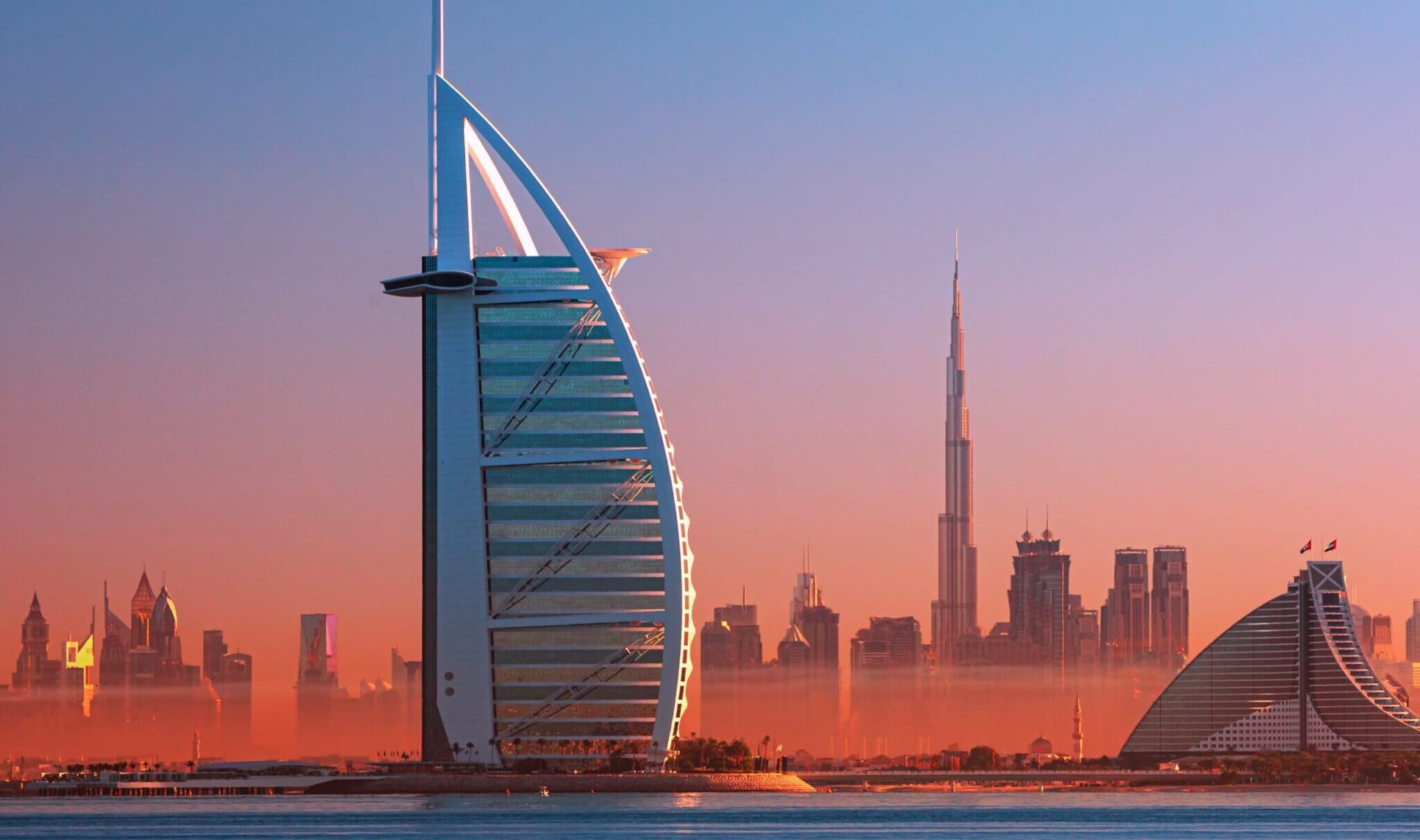 Dubai city - amazing city center skyline and famous Jumeirah beach at sunset, United Arab Emirates